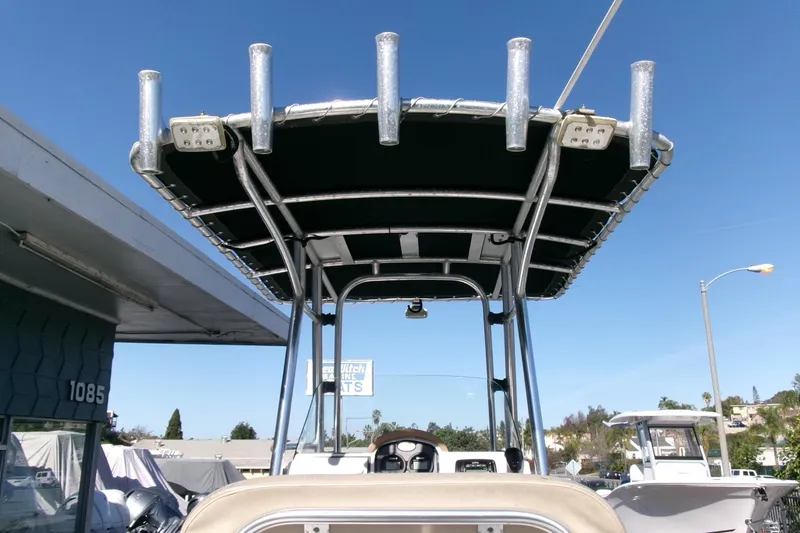 Slide: The Image of 2016 Sea Fox 186 Commander boat with T-top and rod holders under clear blue sky. - 13