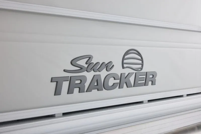 Slide: The Image of Sun Tracker Party Barge 22 DLX 2026 logo on boat exterior. - 14