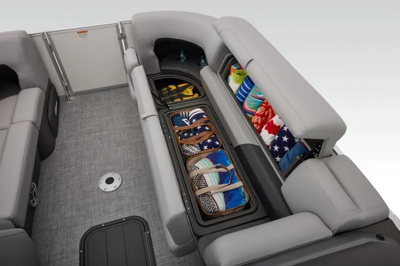 Slide: The Image of 2026 Sun Tracker Party Barge 22 DLX interior with storage compartments and seating. - 21