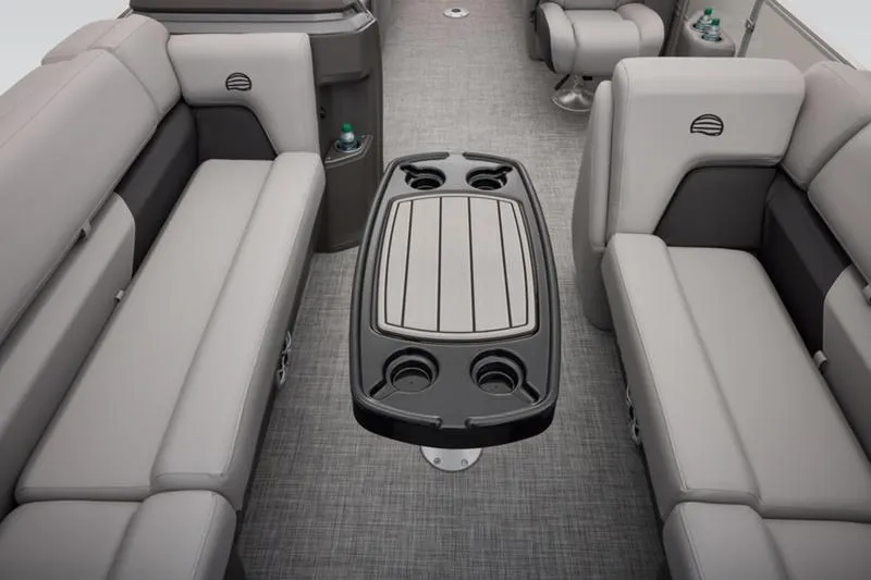 Slide: The Image of 2026 Sun Tracker Party Barge 22 DLX interior with gray seating and central table. - 23
