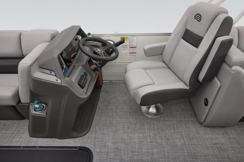 Slide: The Image of 2026 Sun Tracker Party Barge 22 DLX interior with steering console and plush seating. - 31