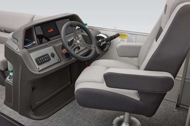 Slide: The Image of 2026 Sun Tracker Party Barge 22 DLX helm with steering wheel and captain's chair. - 34