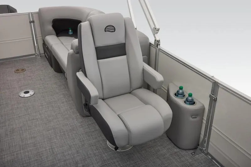 Slide: The Image of 2026 Sun Tracker Party Barge 22 DLX interior with plush seating and cup holders. - 36