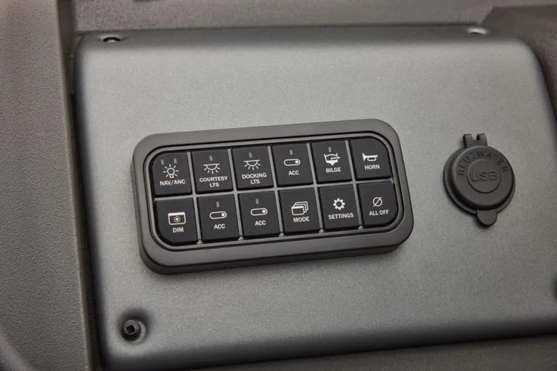 Slide: The Image of Control panel of 2026 Sun Tracker Party Barge 22 DLX with USB port and various switches. - 39