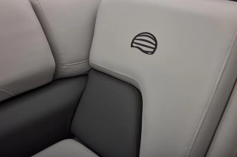 Slide: The Image of 2026 Sun Tracker Party Barge 22 DLX, featuring sleek gray seating with logo detail. - 52