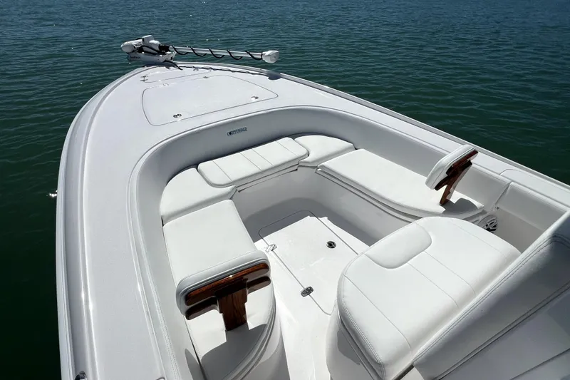Slide: The Image of 2026 Contender 26 Bay boat interior with white seating on calm water. - 10