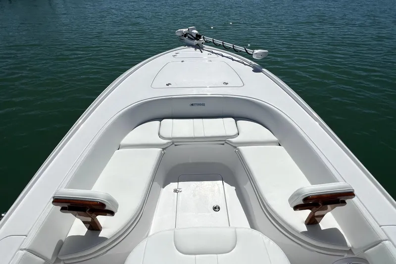 Slide: The Image of 2026 Contender 26 Bay boat with white seating on calm water. - 11