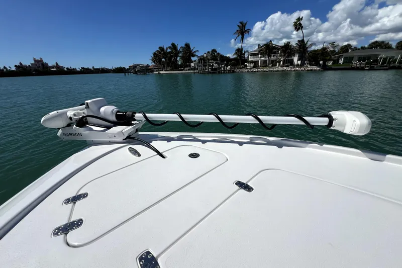 Slide: The Image of 2026 Contender 26 Bay boat with Garmin trolling motor on calm water. - 12