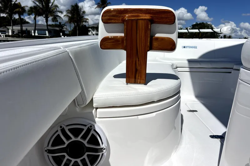 Slide: The Image of 2026 Contender 26 Bay boat interior with white seating and wooden accents. - 16