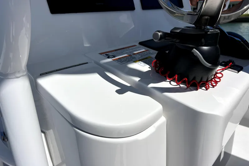 Slide: The Image of 2026 Contender 26 Bay boat console with control lever and safety lanyard. - 23