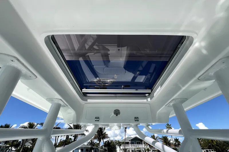 Slide: The Image of 2026 Contender 26 Bay boat roof hatch with clear blue sky background. - 27