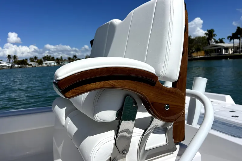 Slide: The Image of Luxury seating on 2026 Contender 26 Bay boat, featuring white upholstery and wooden accents. - 31