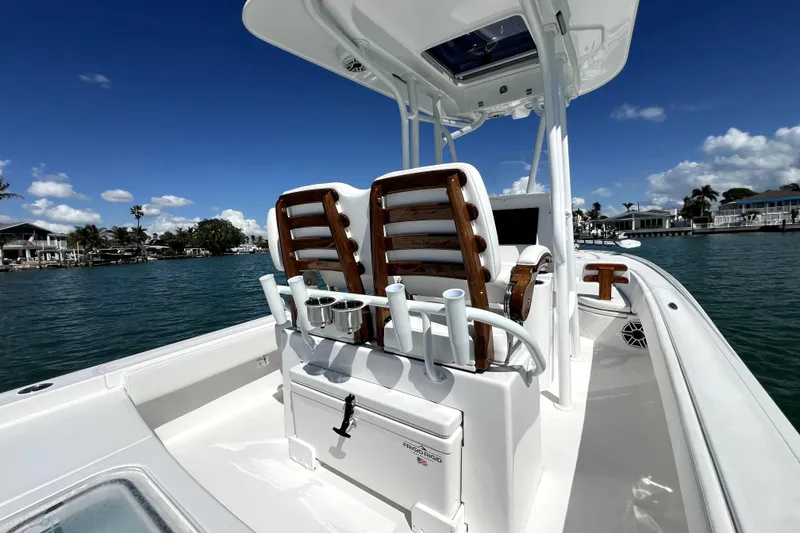 Slide: The Image of 2026 Contender 26 Bay boat on water, featuring sleek design and modern seating. - 33