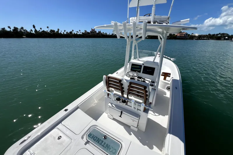 Slide: The Image of 2026 Contender 26 Bay boat on calm water, featuring modern console and seating. - 34