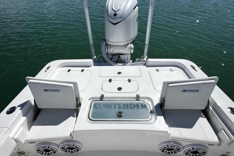 Slide: The Image of 2026 Contender 26 Bay boat deck with seating and motor, on calm water. - 37