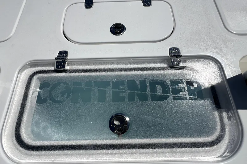 Slide: The Image of Contender 26 Bay 2026 boat deck with storage compartments and logo. - 40