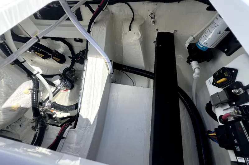 Slide: The Image of Interior view of 2026 Contender 26 Bay boat's engine compartment with wiring and components. - 42