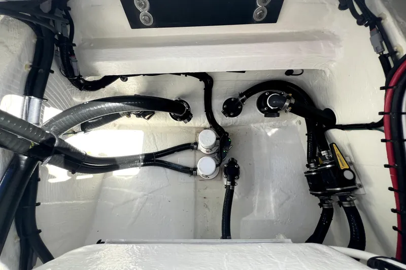 Slide: The Image of Engine compartment of 2026 Contender 26 Bay boat, showcasing hoses and mechanical components. - 43