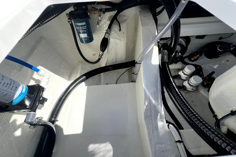 Slide: The Image of Engine compartment of 2026 Contender 26 Bay boat, showcasing filters and wiring. - 44