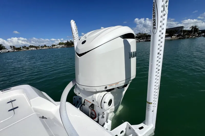Slide: The Image of 2026 Contender 26 Bay boat with Yamaha outboard motor on calm water. - 45