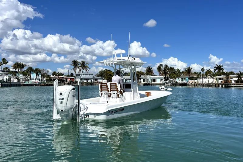 Slide: The Image of 2026 Contender 26 Bay boat on calm water, clear sky, coastal background. - 6