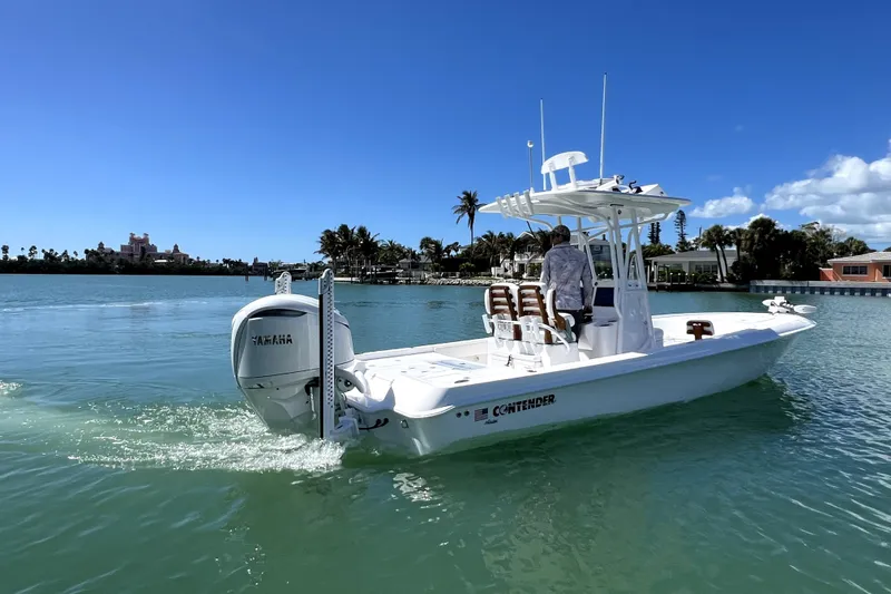 Slide: The Image of 2026 Contender 26 Bay boat cruising on clear blue water under a sunny sky. - 7
