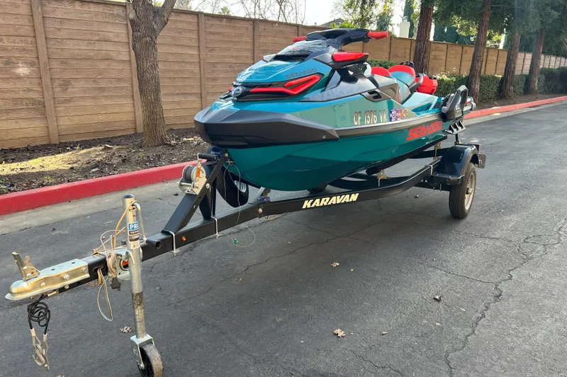 Slide: The Image of 2018 Sea-Doo Wake Pro 230 on a Karavan trailer, parked on a paved road. - 3