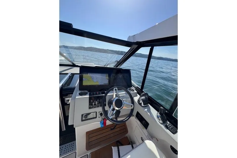 Slide: The Image of 2021 Regal 36 Grande Coupe helm with navigation display on open water. - 1