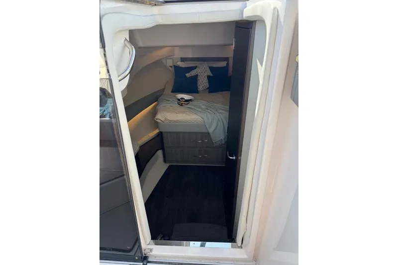 Slide: The Image of Interior cabin of 2021 Regal 36 Grande Coupe with cozy bed and nautical decor. - 10