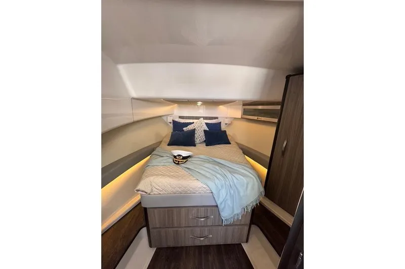 Slide: The Image of Luxurious cabin interior of 2021 Regal 36 Grande Coupe with cozy bedding and ambient lighting. - 11