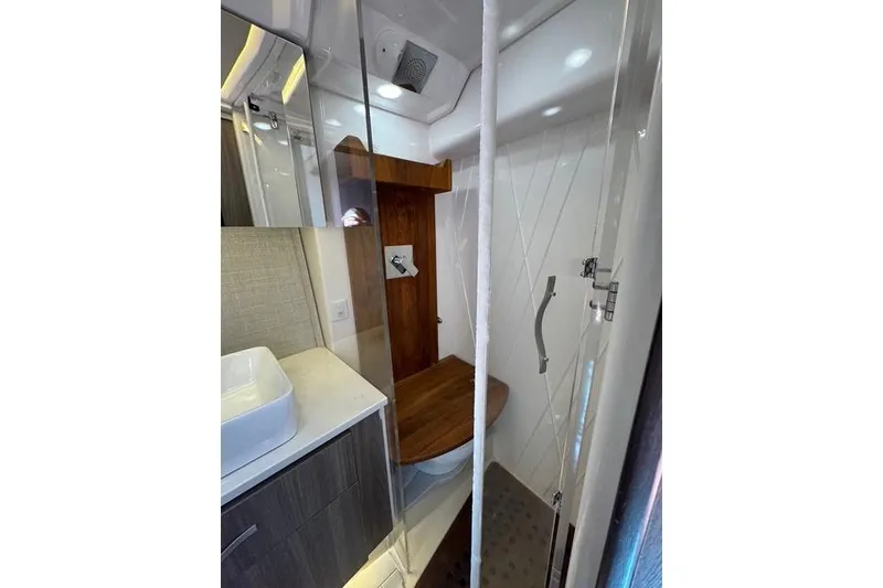 Slide: The Image of Bathroom interior of 2021 Regal 36 Grande Coupe yacht, featuring modern fixtures and wood accents. - 13