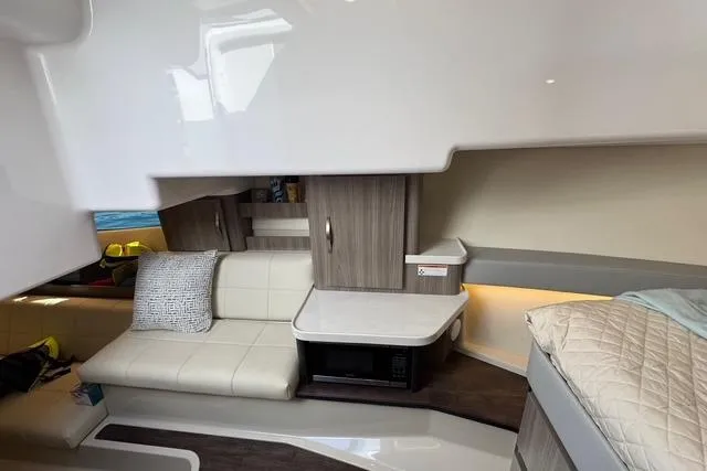 Slide: The Image of 2021 Regal 36 Grande Coupe interior with modern seating and cabinetry. - 16