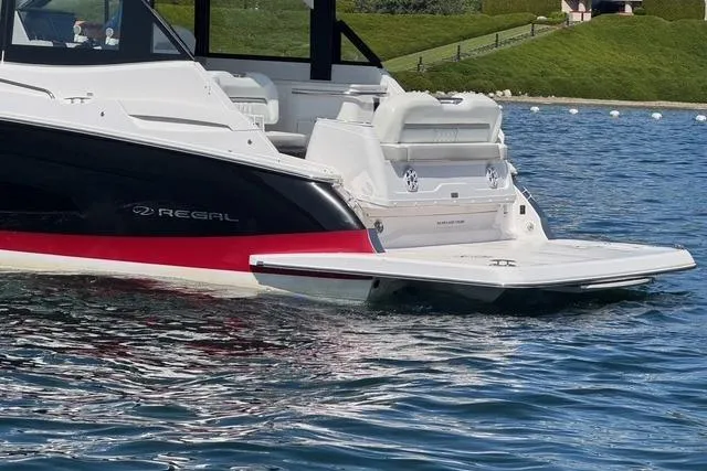 Slide: The Image of 2021 Regal 36 Grande Coupe boat on water, featuring sleek design and spacious seating. - 20