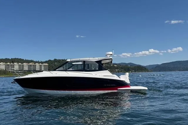 Slide: The Image of 2021 Regal 36 Grande Coupe on serene lake with mountain backdrop. - 21