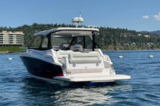 Slide: The Image of 2021 Regal 36 Grande Coupe on a scenic lake with forested hills. - 22