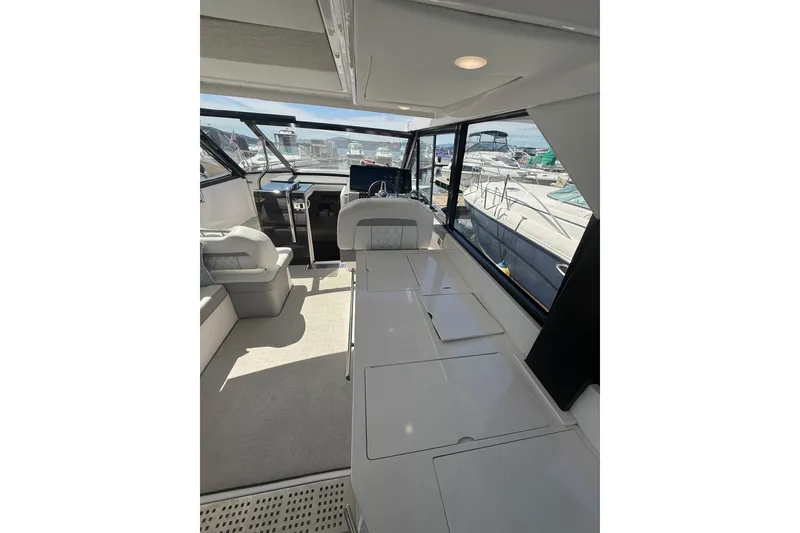 Slide: The Image of Interior of 2021 Regal 36 Grande Coupe yacht, featuring modern seating and helm station. - 39
