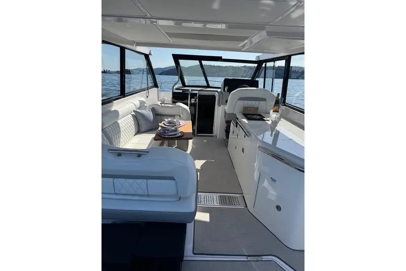 Slide: The Image of Interior of 2021 Regal 36 Grande Coupe yacht with elegant seating and dining area. - 9