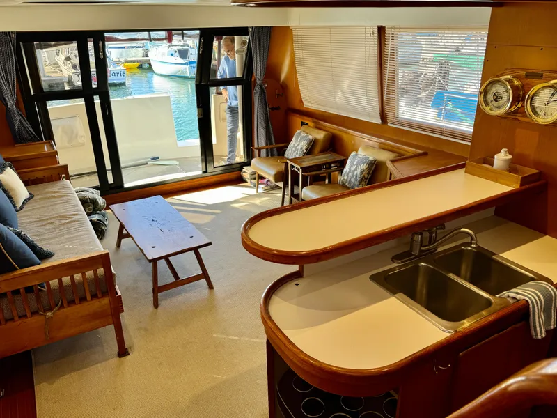 Slide: The Image of Interior of 1997 McKinna 48 Pilothouse yacht with cozy seating and kitchenette. - 14