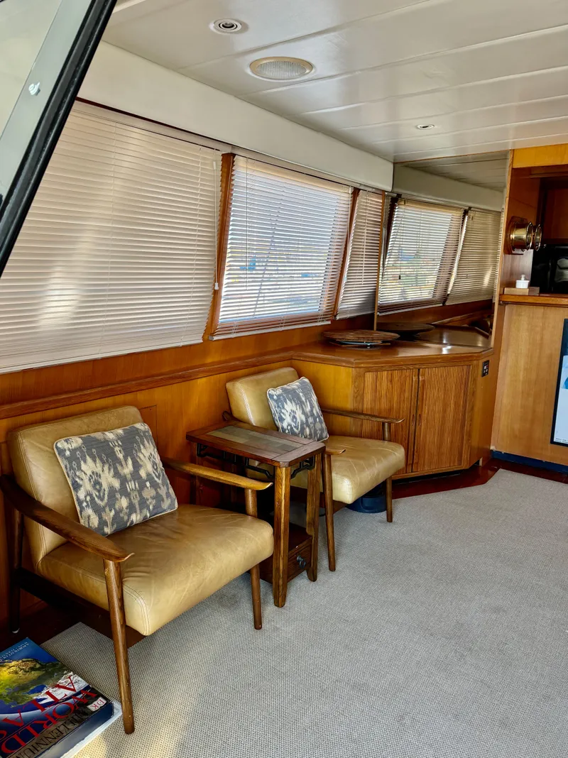 Slide: The Image of Interior of a 1997 McKinna 48 Pilothouse yacht with seating and wooden accents. - 15
