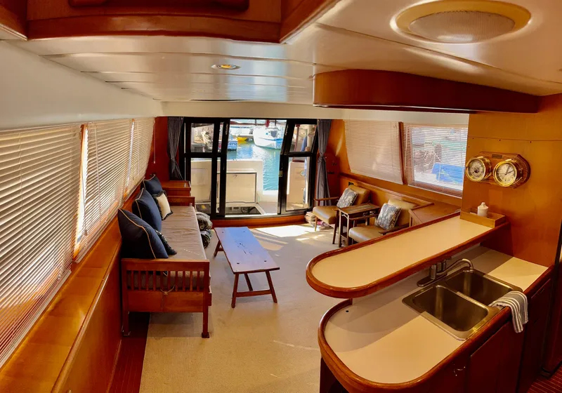Slide: The Image of Interior of 1997 McKinna 48 Pilothouse yacht with cozy seating and kitchenette. - 17