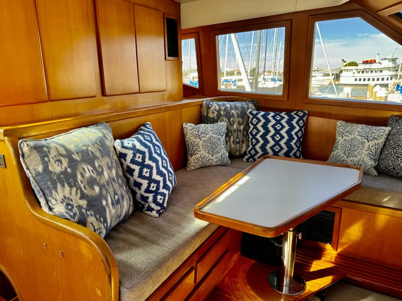 Slide: The Image of Cozy seating area in 1997 McKinna 48 Pilothouse with patterned cushions and wooden interior. - 19