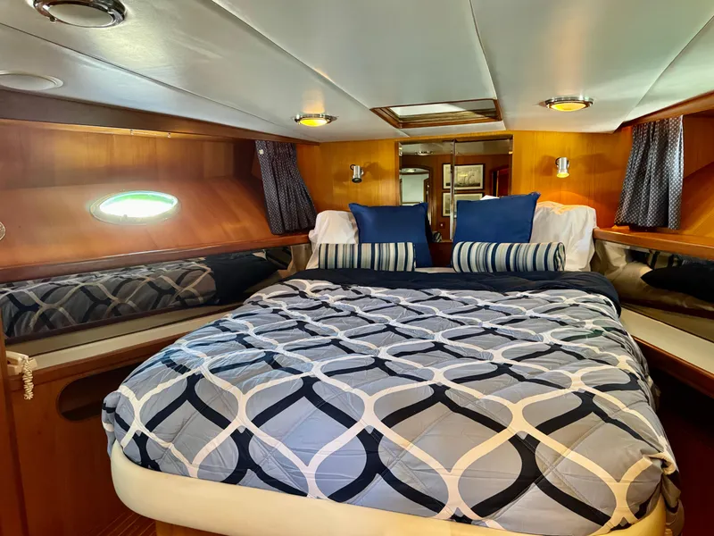 Slide: The Image of Luxurious cabin interior of 1997 McKinna 48 Pilothouse with cozy bedding and elegant wood finish. - 22