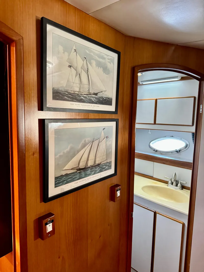 Slide: The Image of Interior of 1997 McKinna 48 Pilothouse with nautical artwork and bathroom view. - 24