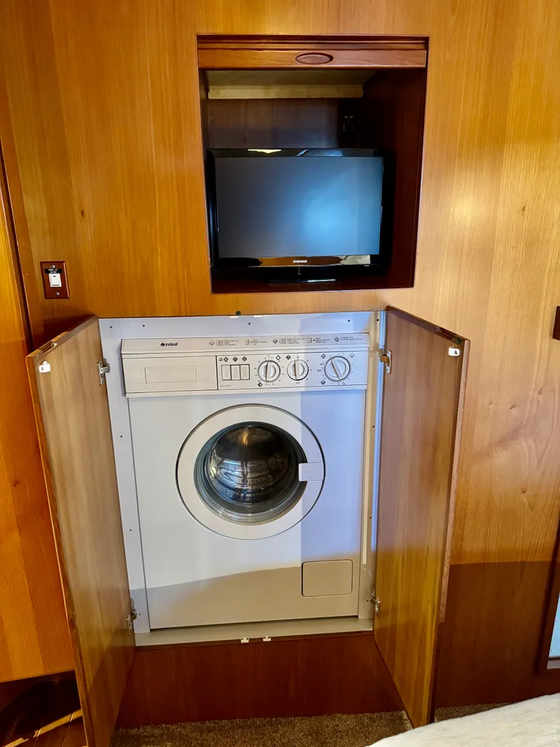 Slide: The Image of Washer and TV in 1997 McKinna 48 Pilothouse yacht interior, wood paneling. - 29