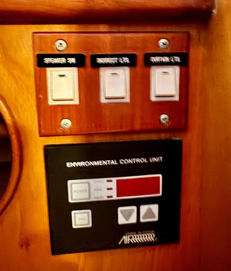 Slide: The Image of Control panel on a 1997 McKinna 48 Pilothouse yacht with switches and environmental unit. - 31