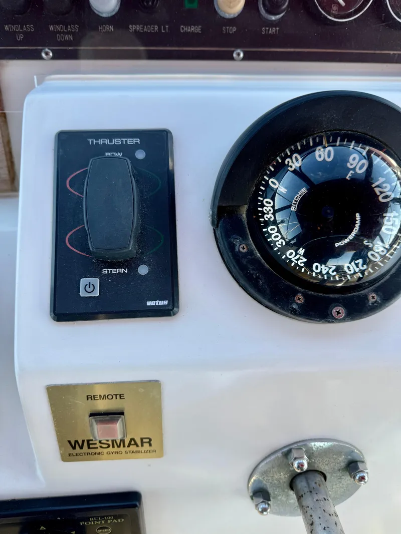 Slide: The Image of Control panel of a 1997 McKinna 48 Pilothouse with compass and thruster controls. - 37