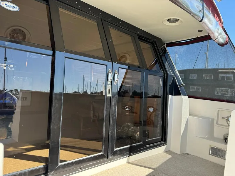 Slide: The Image of 1997 McKinna 48 Pilothouse yacht with glass sliding doors and marina view. - 40