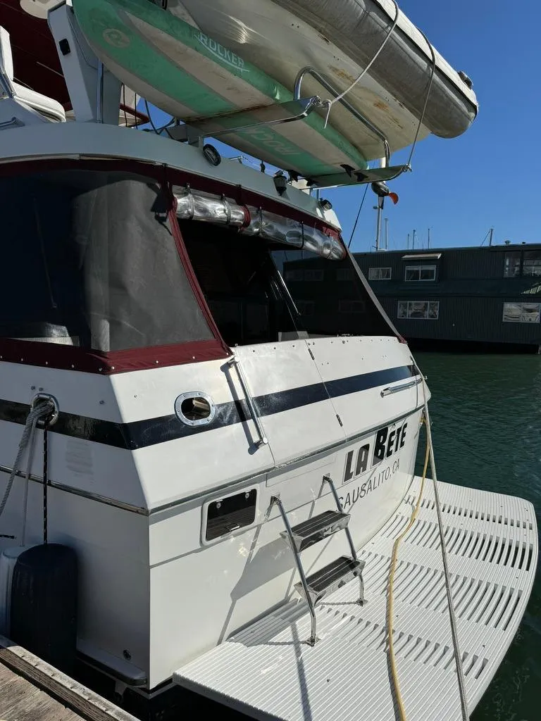 Slide: The Image of 1997 McKinna 48 Pilothouse yacht docked with paddleboards on top. - 41