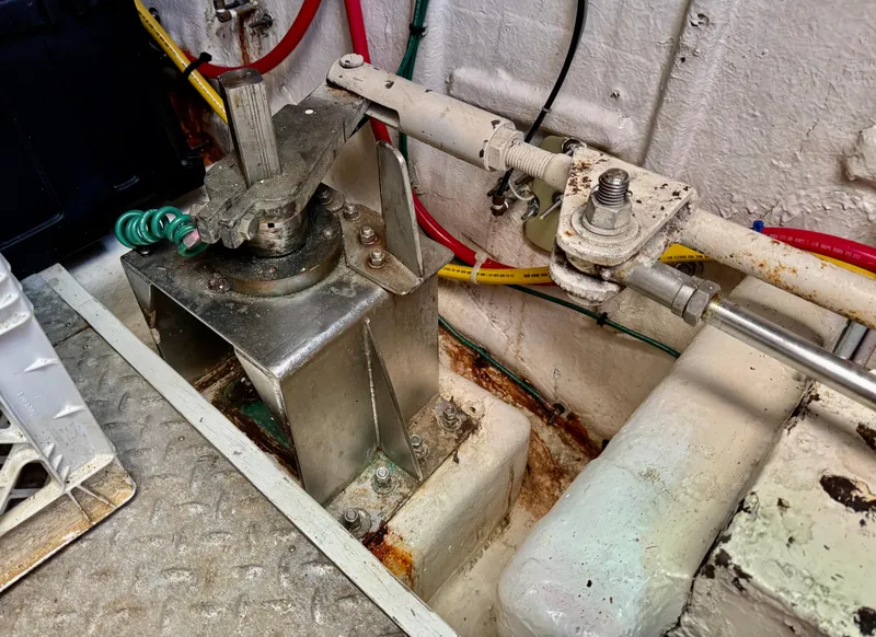 Slide: The Image of Engine room detail of a 1997 McKinna 48 Pilothouse, showing mechanical components and wiring. - 43