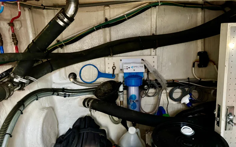 Slide: The Image of Engine room of 1997 McKinna 48 Pilothouse with plumbing and filtration system. - 45